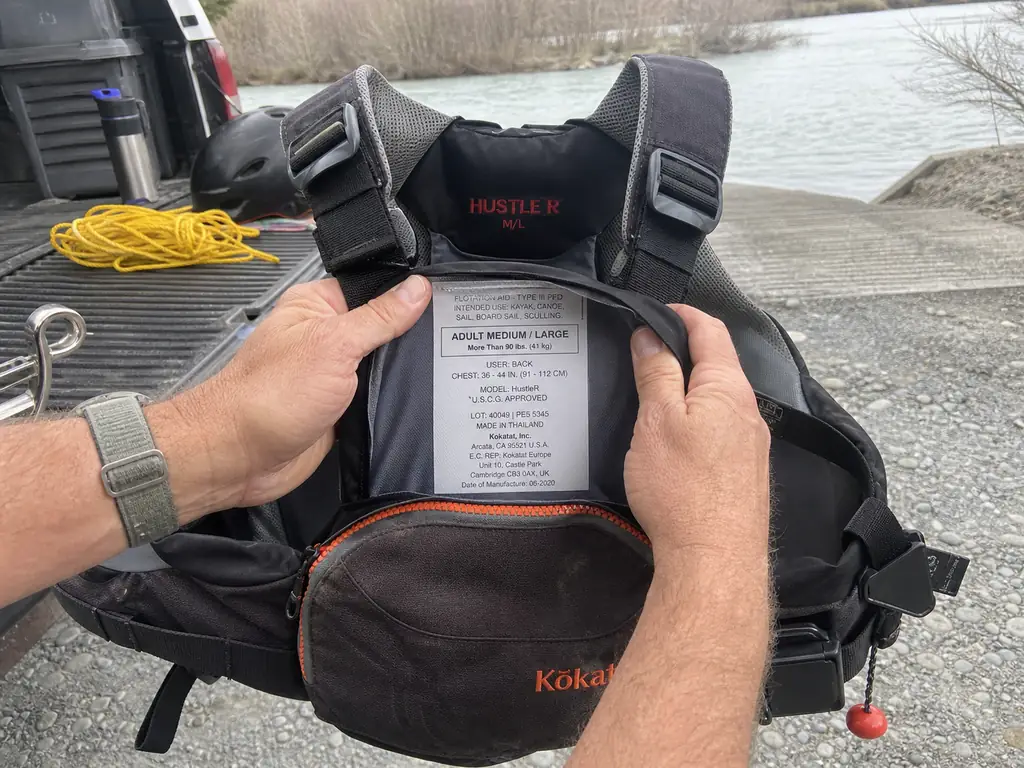 Close-up of the USCG Type V label sewn inside a Kokatat HustleR rescue PFD