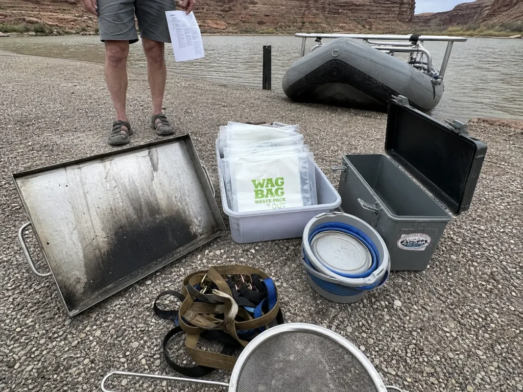 Permit-required river camping gear staged at a Green River put-in before launch
