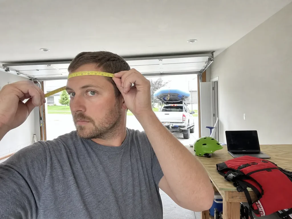 Measuring head circumference with a soft tape before choosing a helmet size